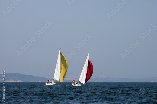 Sailing boats racing under color sails