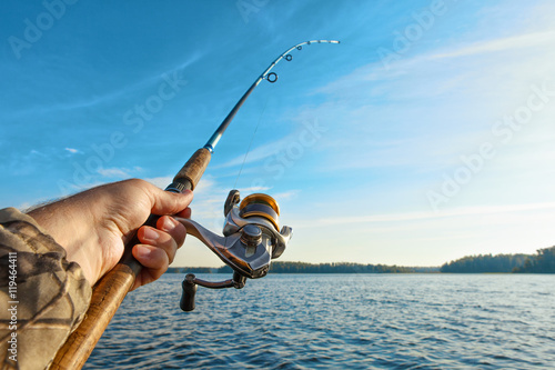 fishing on a lake at sunrise