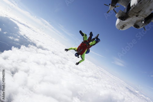 Two skydivers in tandem jumping from the plane.