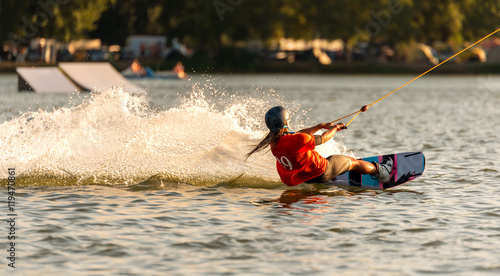 Young active woman on the wakeboard in cable park Merkur, Nove Mlyny, South Moravia, Czech Republic
