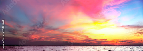 Tropical colorful dramatic sunset with cloudy sky. Evening calm on the Gulf of Thailand. Bright afterglow.
