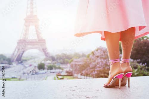 beautiful fashion woman on high heels near Eiffel tower in Paris, France