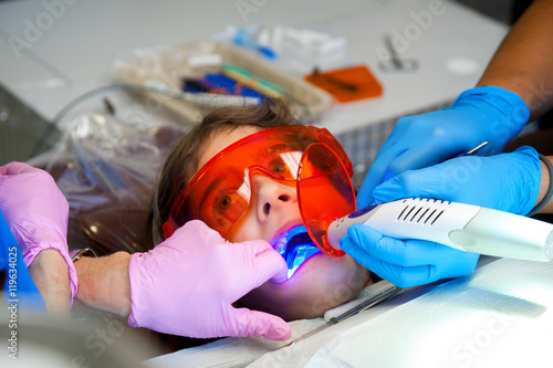 Girl in Orange Protective Glasses Gets Teeth Sealed