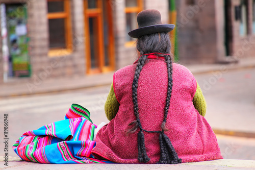 Local woman sitting at Plaza de Armas in Cusco, Peru