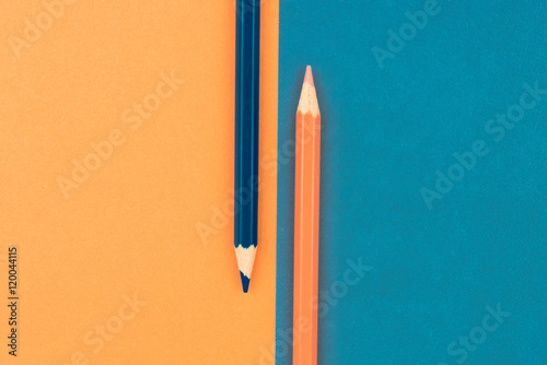 Orange and Dark Blue coloured pencils and paper