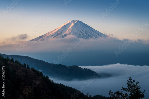 Mount Fuji enshrouded in clouds with clear sky from lake kawaguchi, Yamanashi, Japan