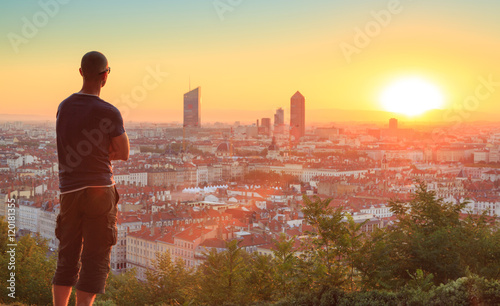 Man enjoying the sunrise over the city of Lyon, France.