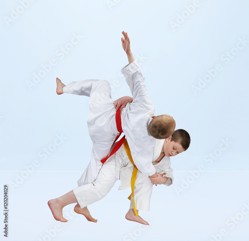 Sportsmen are training judo throws
