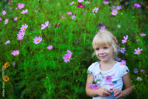 beautiful girl with flowers Cosmos outdoor