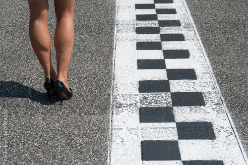 Woman sexy legs on motorsport asphalt track