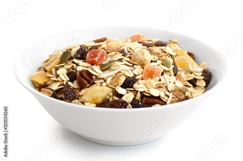 Breakfast bowl of fruit and nut muesli isolated on white.