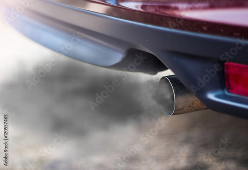 combustion fumes coming out of car exhaust pipe