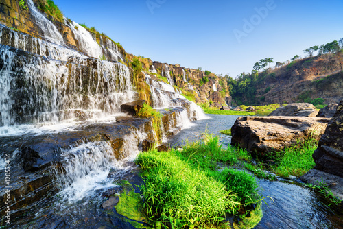 Side view of natural cascading waterfall with clear water