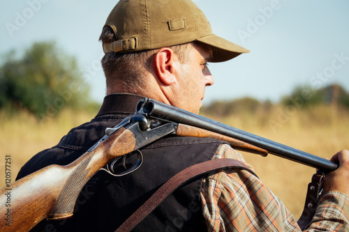 Hunter With Open Shotgun On Shoulder