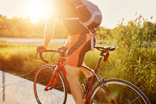 Young man are cycling road bike in the evening