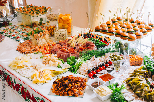 Buffet table of reception with burgers, cold snacks, meat and salads