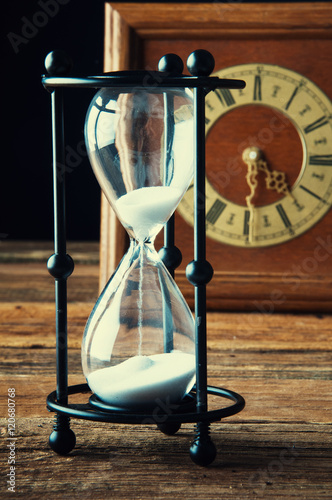 Hourglass and old vintage clock