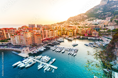 Panoramic view of Port de Fontvieille in Monaco. Azur coast. Colorful bay with a lot of luxury yachts in sunset.