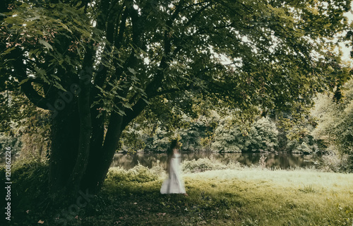 Walking woman in a white dress