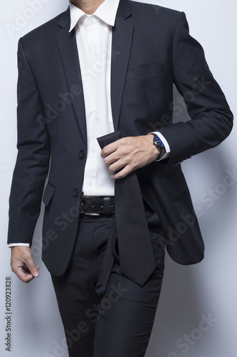 Businessman hold his necktie