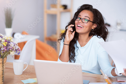 Joyful smiling woman talking on cell phone