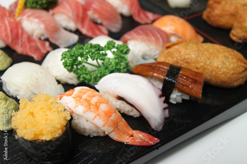Wooden tray of sushi with shrimp, octopus and tuna