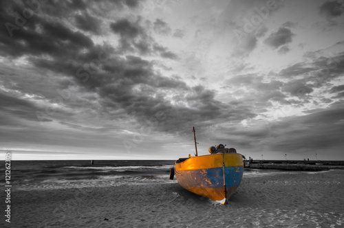 sunset over the sea beach,fishing boat, selective color