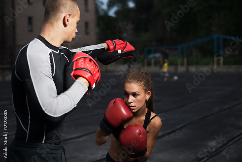 personal trainer coach men and women engaged in boxing at the stadium