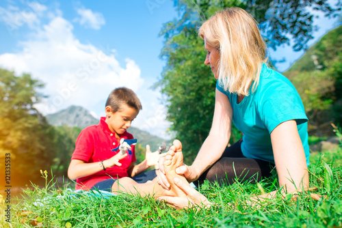 Naturopath practicing reflexology at the foot of a child