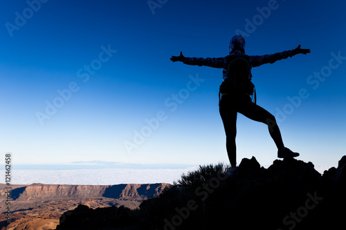 Woman success concept silhouette on mountain top