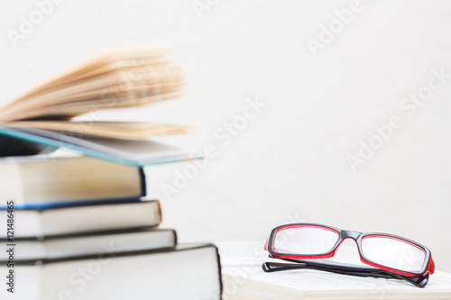 Books stacked glasses on the table