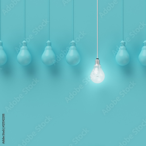 Hanging light bulbs with glowing one different idea on light blue background , Minimal concept idea , flat lay , top