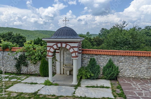 View of inner part yard with spring water fountain in restored Montenegrin or Giginski monastery St. St. Cosmas and Damian, mountain Kitka, Breznik, Pernik region, Bulgaria