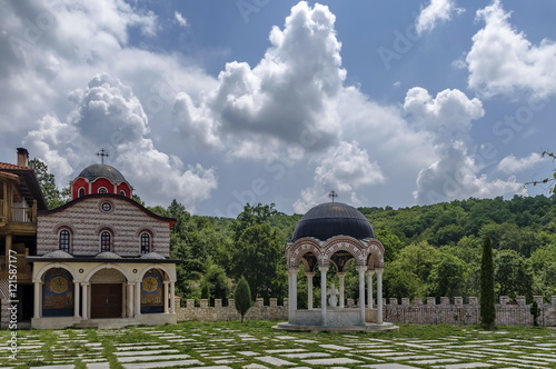 View of inner part yard with new monastic house, alcove and new church, in restored Montenegrin or Giginski monastery St. St. Cosmas and Damian, mountain Kitka, Breznik, Pernik region, Bulgaria 