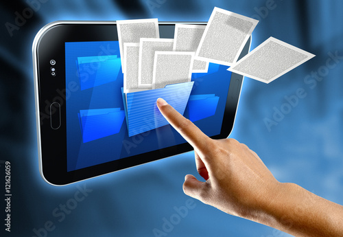 A woman's finger select a folder on a digital tablet