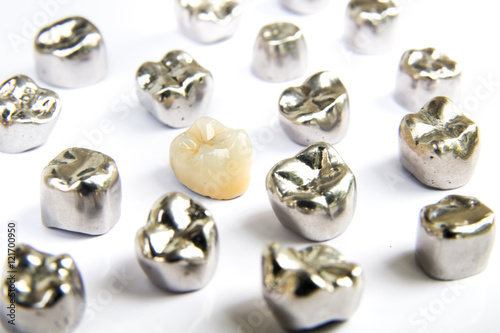 Dental ceramic, gold and metal tooth crowns on white background. Isolated.