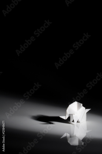 Origami art, colored elephant isolated over a black background