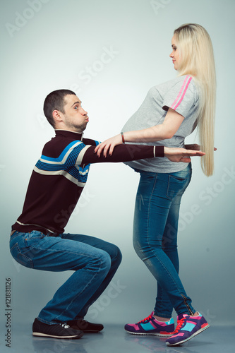 Healthy pregnancy concept. Funny full length portrait of happy hipsters