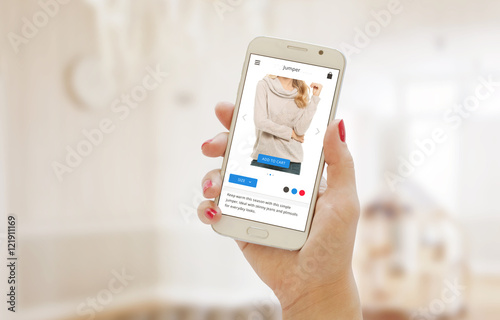 Modern shopping app on smart phone in the women hand. Buying clothes on web site or app.