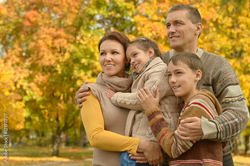 Family relaxing in autumn park