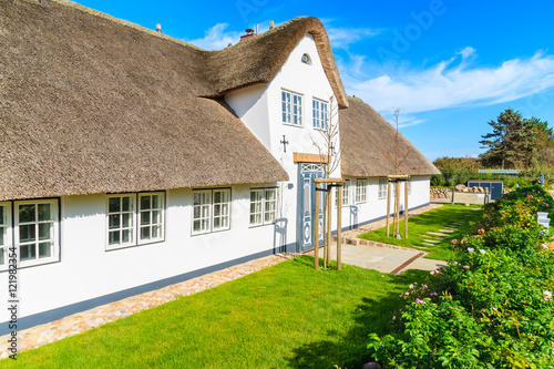 Traditional white house with thatched roof in Wenningsted village on Sylt island, Germany