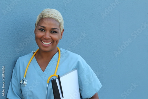 Copy-spaced portrait of a friendly general practitioner holding a medical record isolated over blue background