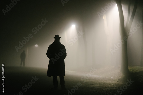 Two men in an empty park, one at far distance