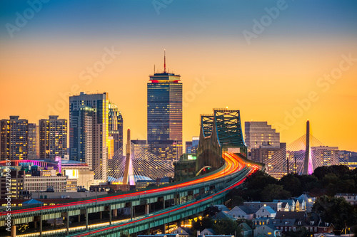 Rush hour traffic on Tobin bridge (aka Mystic River bridge) heading towards Zakim bridge and Boston skyline at sunset.