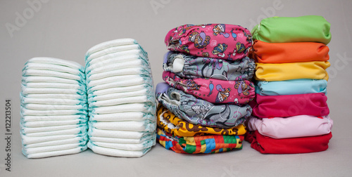 Stacks of disposable diapers and modern cloth diapers