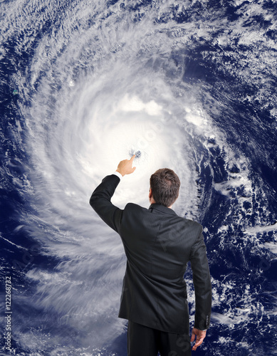 Television meteorologist weatherman forecasting putting finger on eye of hurricane cyclone typhoon