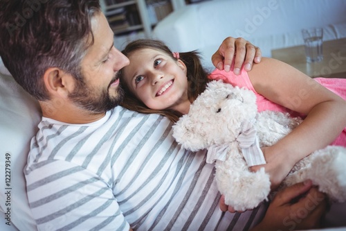 Father and daughter embracing on sofa