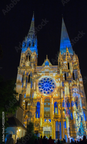 The illuminated Our Lady of Chartres cathedra at night , France.