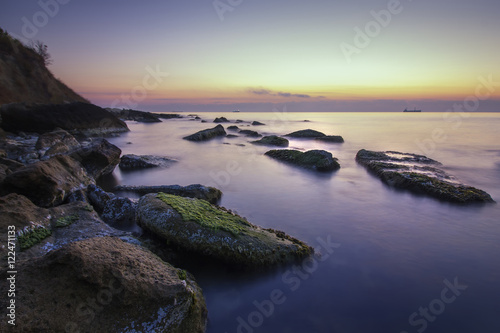 beauty and calm rocky sea before sunrise .
