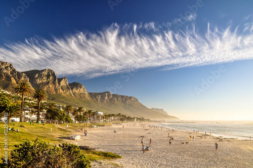 Stunning evening photo of Camps Bay, an affluent suburb of Cape Town, Western Cape, South Africa. With its white beach, Camps Bay attracts a large number of foreign visitors as well as South Africans.